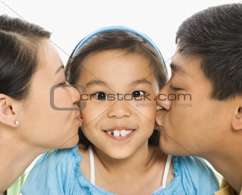 Parents kissing girl.