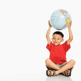 Boy holding globe.