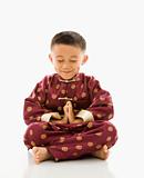 Asian boy meditating.