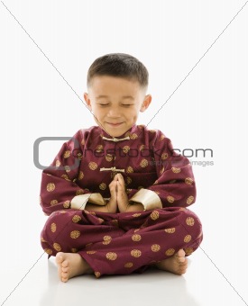 Asian boy meditating.