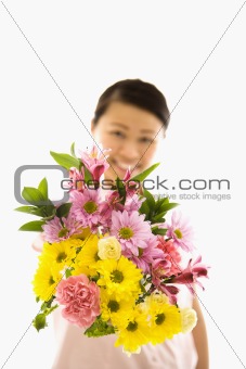 Asian woman holding flowers.