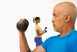 Man exercising with dumbbell.