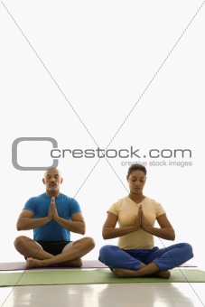 Two people practicing yoga.