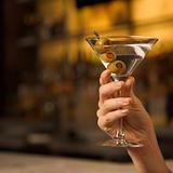 Female hand holding martini.