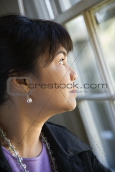 Woman gazing out window.