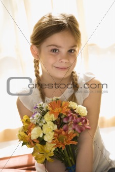 Girl holding flowers.