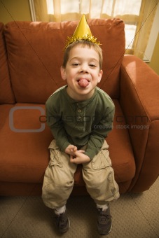 Boy sticking out tongue.