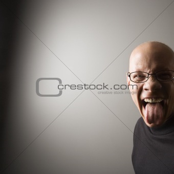 Man sticking out tongue.