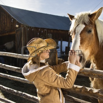 Woman petting horse.