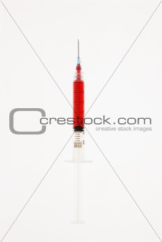 Needle with red liquid.