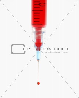 Needle with red liquid.