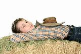 Country boy resting on hay