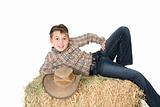Rural child lying on hay bale