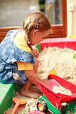 Child playing in sandbox