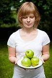 Girl holding fresh green apples
