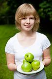Girl holding fresh green apples