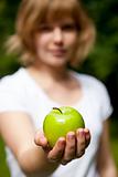 Girl holding a fresh green apple