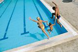 happy young family have fun on swimming pool 