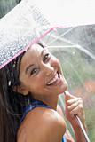 Young Woman Using an Umbrella in Rain