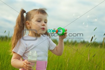 Little girl starts soap bubbles