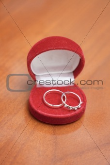 Red casket with two wedding rings