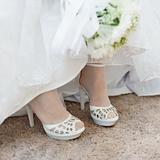 Shoes of bride under wedding dress