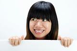 asian girl smiling with a blank card board