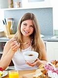 Bright caucasian woman eating cereals with strawberries 