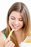Happy young woman eating fries 