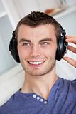 Handsome young man listening to music with headphones