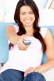 Captivating asian woman holding a remote smiling