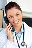Delighted female doctor talking on phone