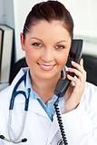 Smiling female doctor talking on phone