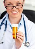 Glowing young female doctor holding pills