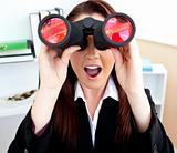 astonished young business woman using binoculars
