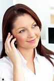 Positive businesswoman talking on phone sitting