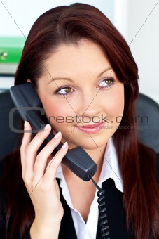 Pretty businesswoman talking on phone sitting