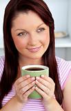 Positive woman holding a cup of coffee