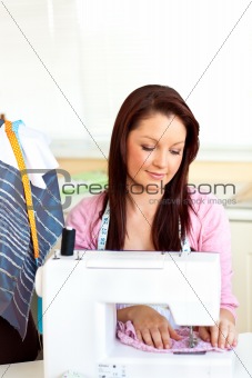 Concentrated caucasian woman sewing at home
