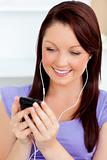 Charming woman listen to music using her cellphone