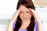 Young woman with headache at home 