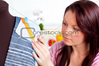 Concentrated woman sewing at home 