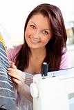 Attractive woman sewing at home 