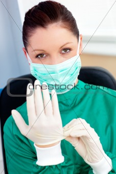 Sophisticated surgeon wearing scrubs and a mask in a hospital