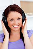 Smiling pretty woman listen to music with headphones