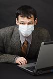 Man in medical mask works in Internet