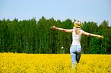 happy young woman is standing on a field