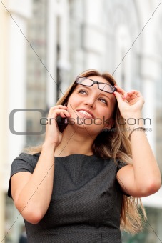 beautiful young businesswoman talking by mobile phone