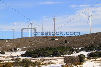 aerogenerator windmills on snow mountain
