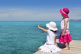 two girls tourist turquoise sea goodbye hand gesture